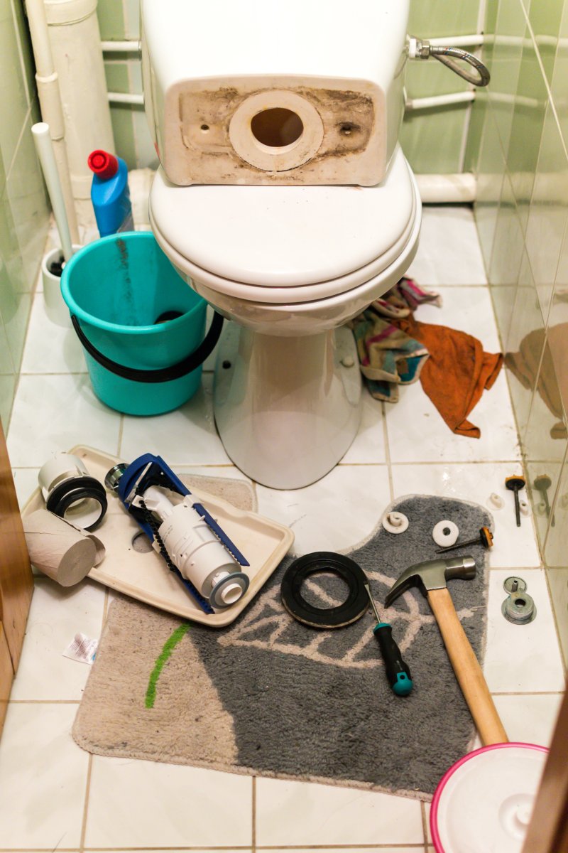 New toilet being installed in a Acton bathroom